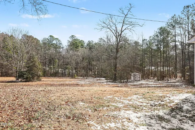 a view of a yard with snow on the road
