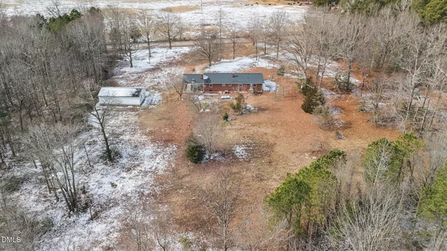 a backyard of a house with a yard and outdoor seating