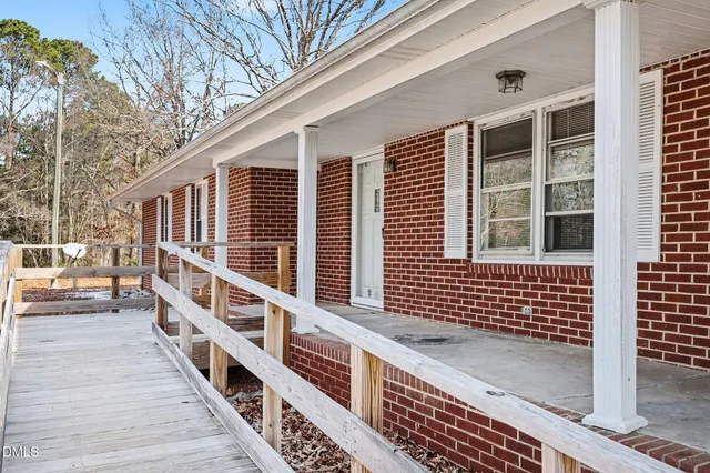a balcony with wooden floor and white fence