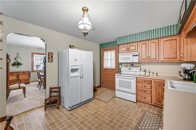 a kitchen with stainless steel appliances a refrigerator sink and cabinets