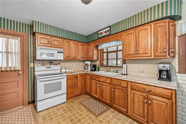 a kitchen with stainless steel appliances granite countertop a sink and cabinets