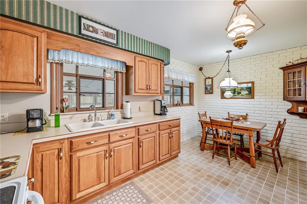 393 South 7th Street Sharpsville, PA 16150 - Photo 18 of 50 a dining hall with stainless steel appliances granite countertop a sink a stove a dining table and chairs with wooden floor