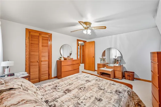 a bedroom with a bed and dresser with mirror