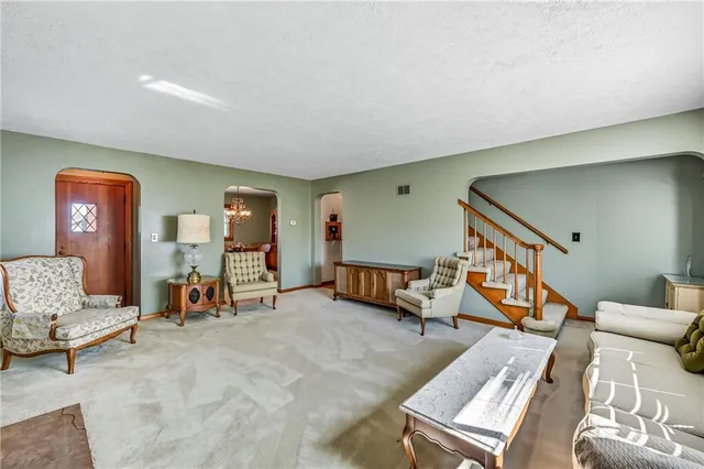 a living room with furniture and a lamp