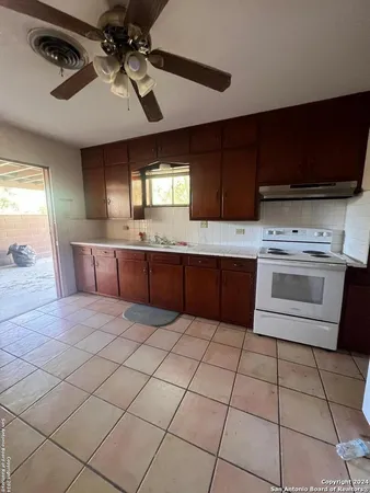 a kitchen with stainless steel appliances a stove a sink and a refrigerator