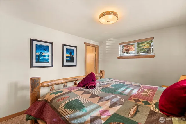 a bedroom with a bed and a lamp