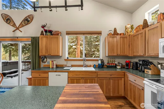 a kitchen filled with lots of counter top space and a sink