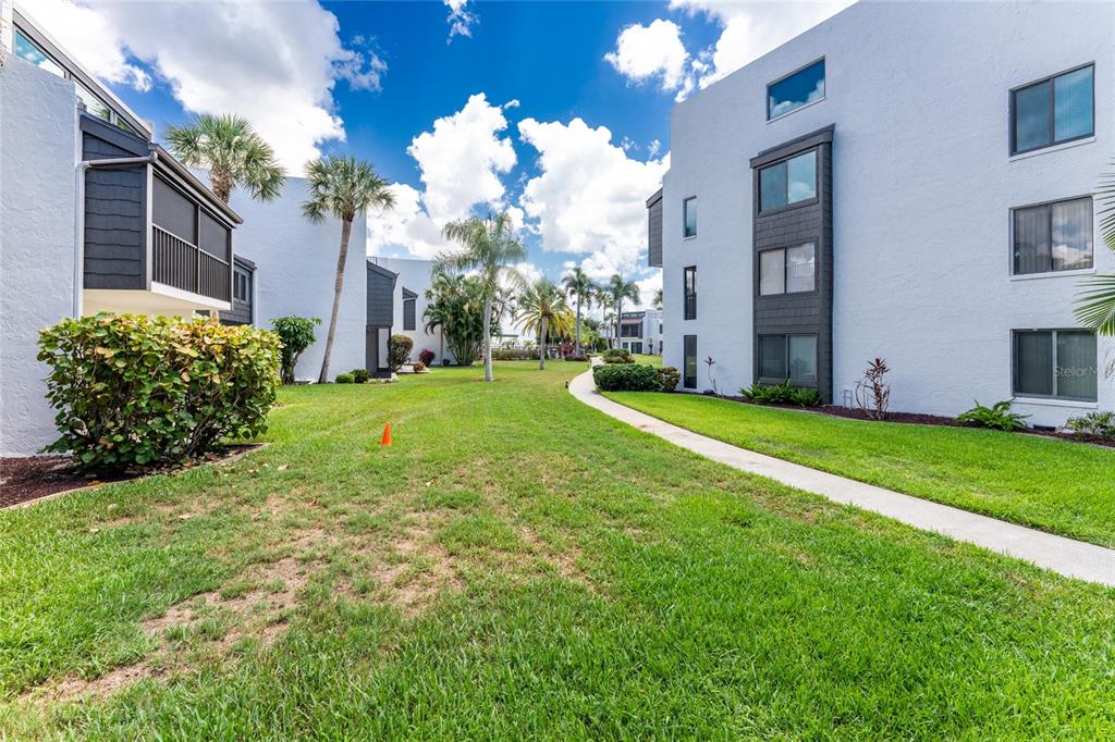 2955 North Beach Road, Unit B614 Englewood, FL 34223 - Photo 35 of 67 a view of a house with a big yard and large windows