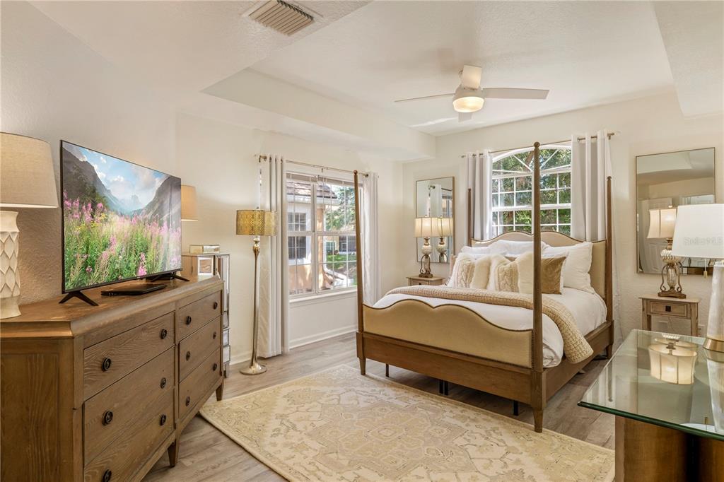 7420 Cypress Grove Road, Unit 132 Orlando, FL 32819 - Photo 14 of 52 a bedroom with a bed and large windows