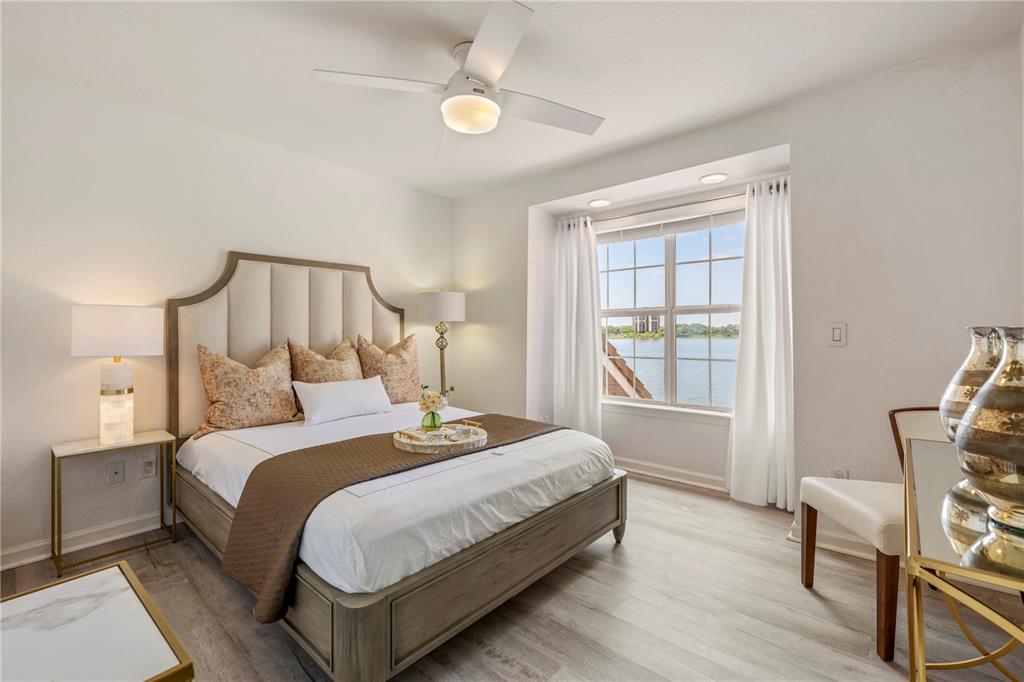 7420 Cypress Grove Road, Unit 132 Orlando, FL 32819 - Photo 18 of 52 a bedroom with bed and window with wooden floor