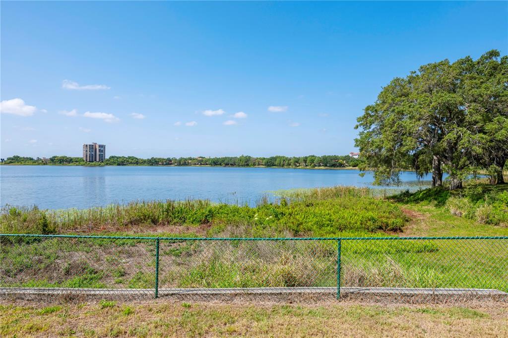 7420 Cypress Grove Road, Unit 132 Orlando, FL 32819 - Photo 25 of 52 a view of a lake with houses in the back