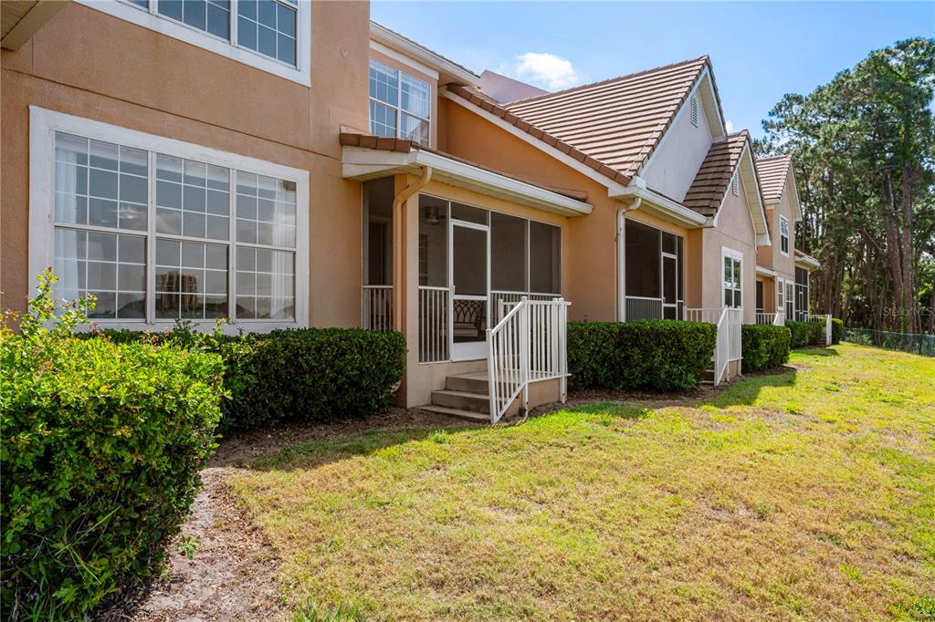 7420 Cypress Grove Road, Unit 132 Orlando, FL 32819 - Photo 26 of 52 a front view of a house with a yard outdoor seating and garage