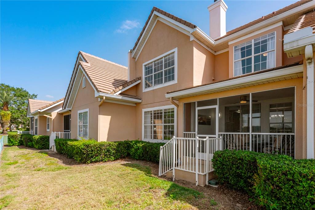 7420 Cypress Grove Road, Unit 132 Orlando, FL 32819 - Photo 27 of 52 a view of a brick house with plants and large tree