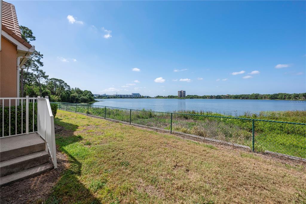 7420 Cypress Grove Road, Unit 132 Orlando, FL 32819 - Photo 28 of 52 a view of an outdoor space and a lake view in the back