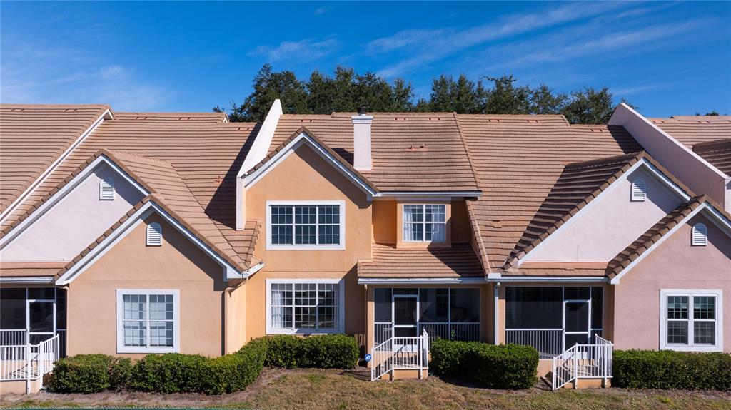 7420 Cypress Grove Road, Unit 132 Orlando, FL 32819 - Photo 30 of 52 a view of a white house next to a yard