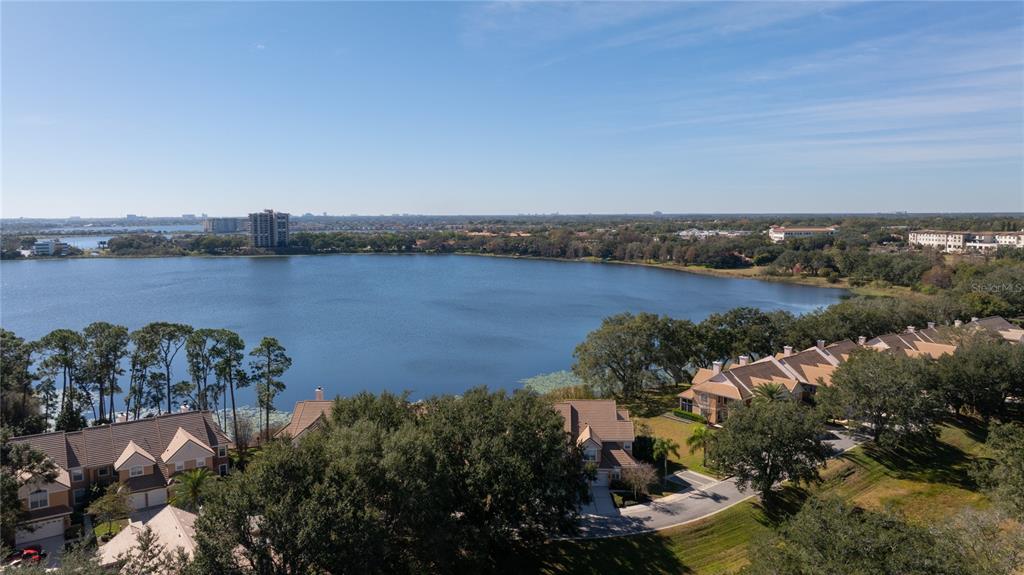 7420 Cypress Grove Road, Unit 132 Orlando, FL 32819 - Photo 33 of 52 an aerial view of a residential houses with outdoor space and lake view