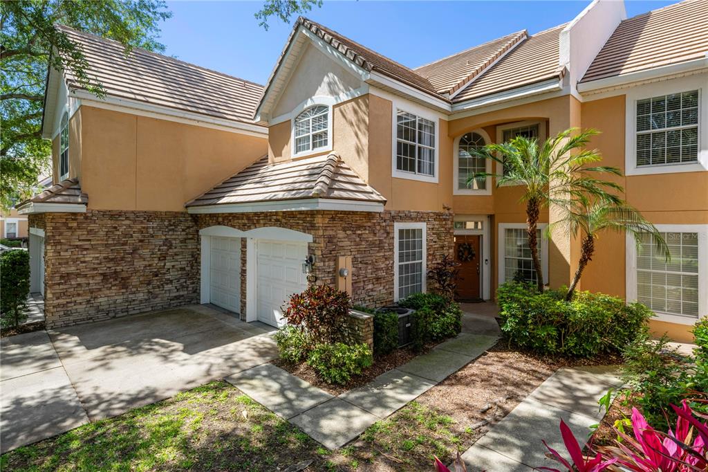 7420 Cypress Grove Road, Unit 132 Orlando, FL 32819 - Photo 47 of 52 a front view of a house with a yard