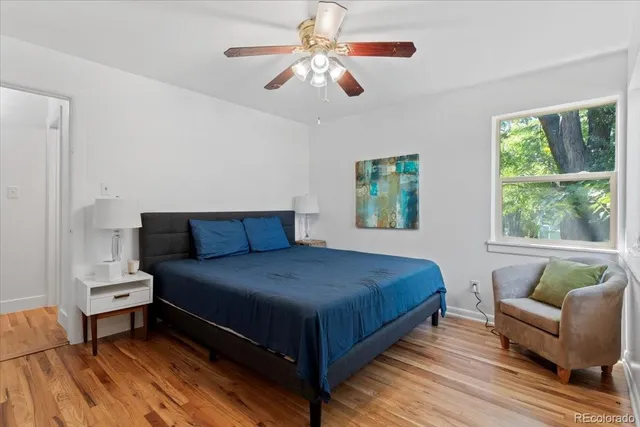 a bedroom with a bed couch and window