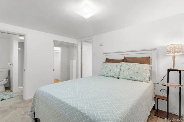 a bedroom with a bed and a night stand