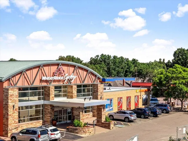a view of building with car parked