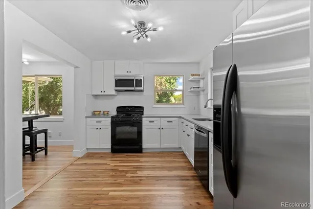 a kitchen with a refrigerator stove and microwave