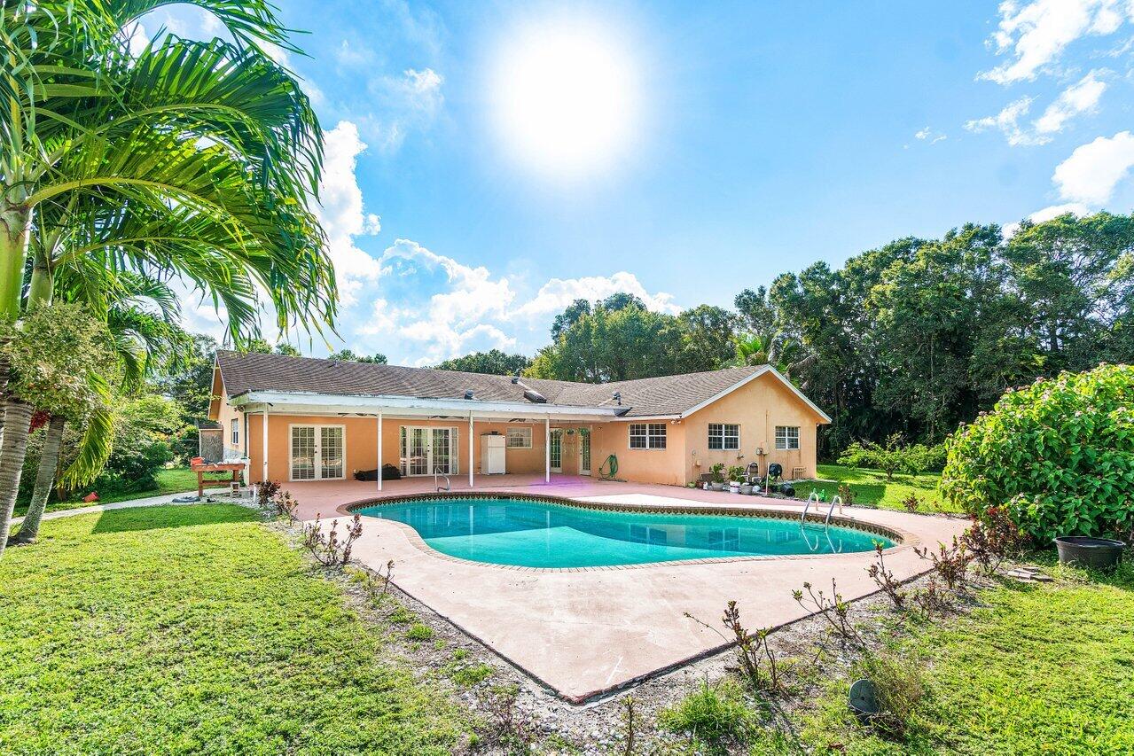 5313 Colbright Road Lake Worth, FL 33467 - Photo 4 of 70 a view of a house with a yard and potted plants