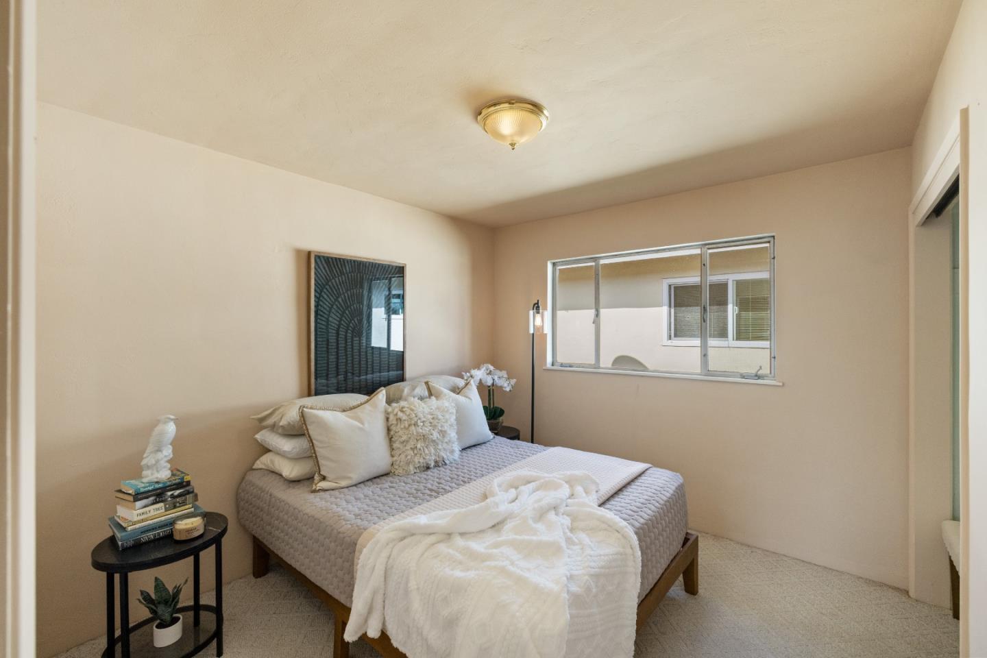 662 Oak Street Monterey, CA 93940 - Photo 16 of 32 a bedroom with a bed and a window