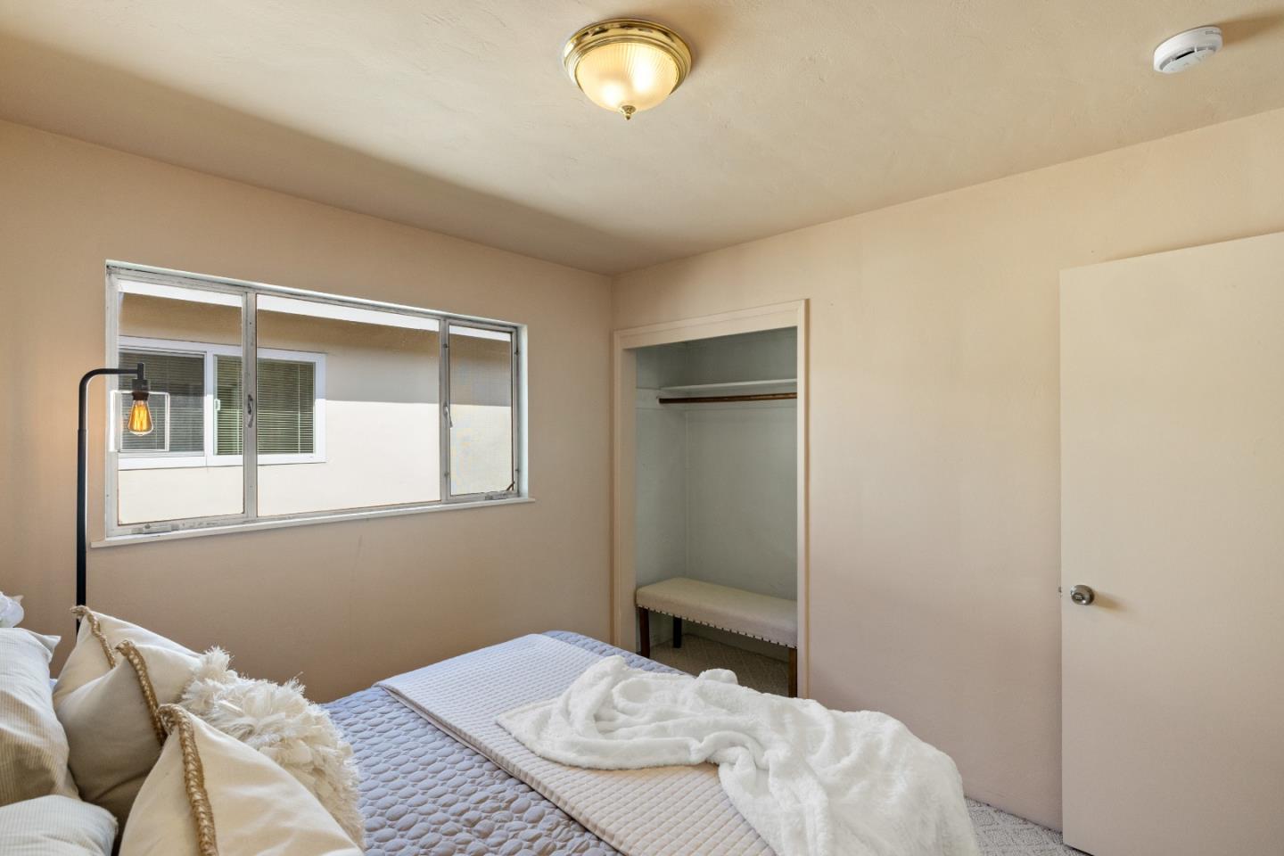 662 Oak Street Monterey, CA 93940 - Photo 17 of 32 a bedroom with a bed and a window