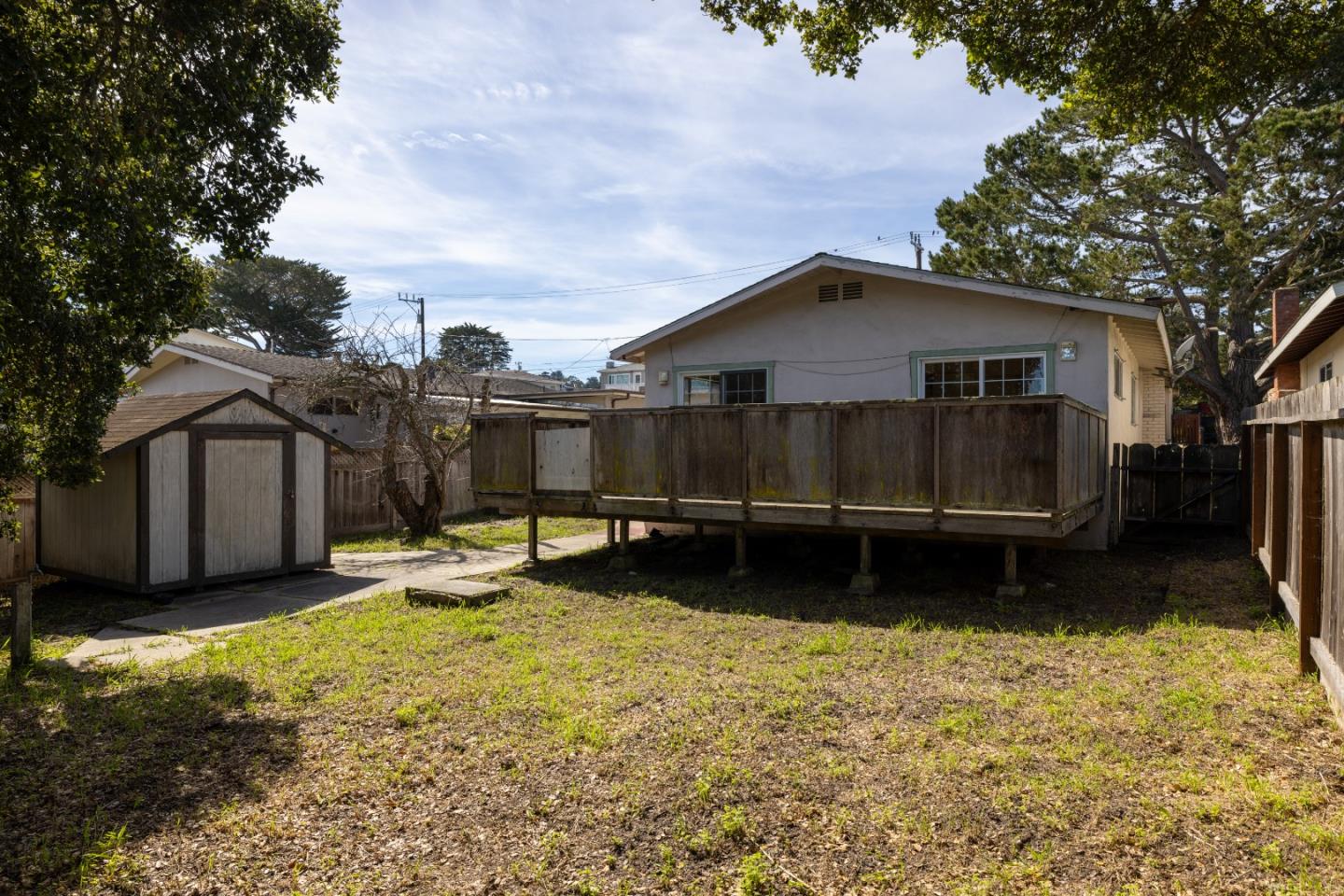 662 Oak Street Monterey, CA 93940 - Photo 28 of 32 a view of a house with a yard covered with snow in the yard