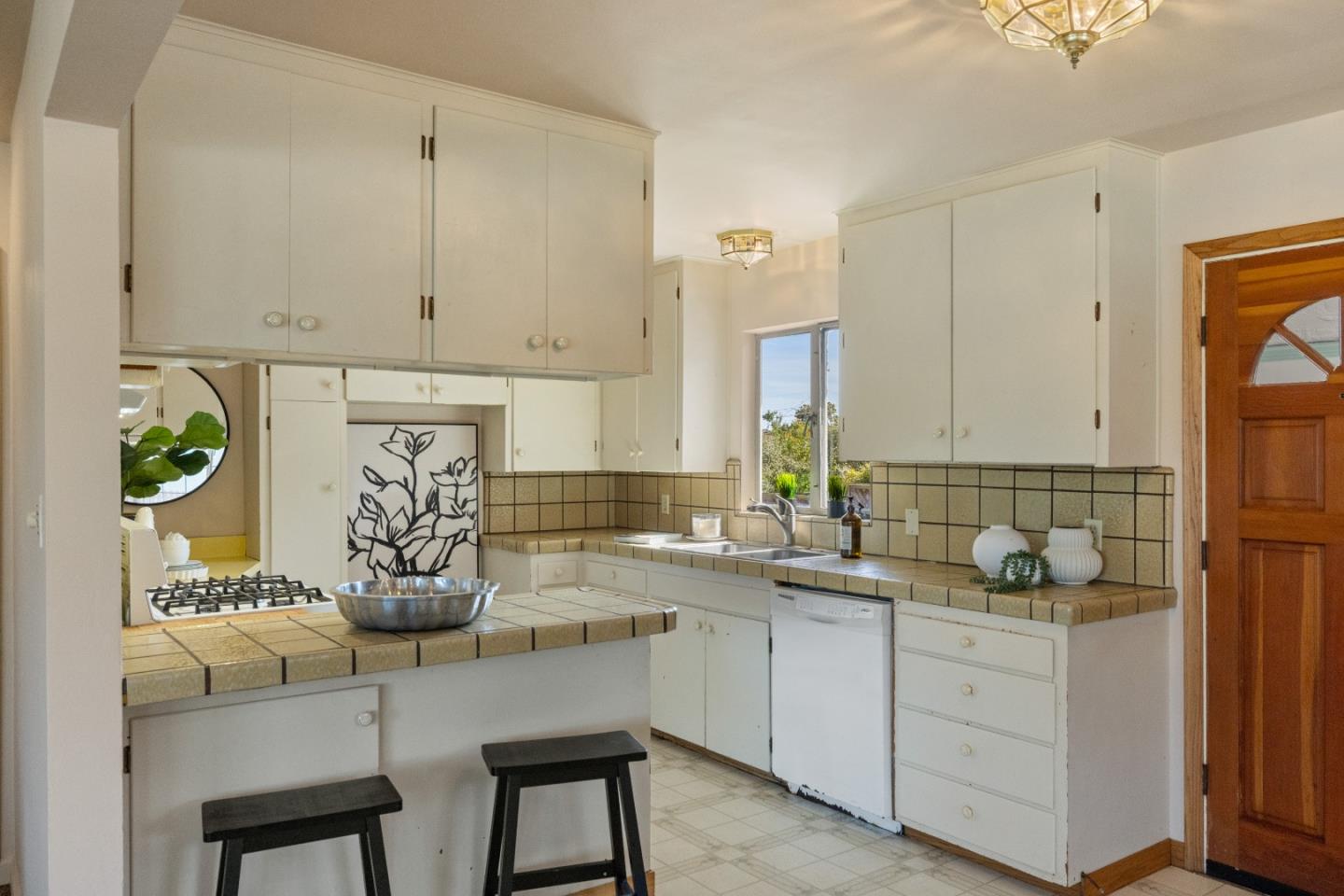 662 Oak Street Monterey, CA 93940 - Photo 9 of 32 a kitchen with stainless steel appliances white cabinets and a stove top oven