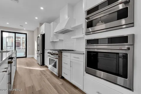 a kitchen with stainless steel appliances a stove microwave and refrigerator