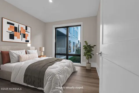 a bedroom with a bed and a potted plant