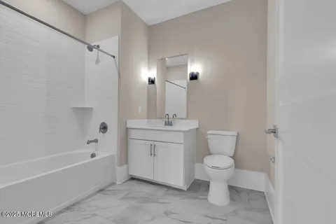 a bathroom with a toilet sink and bathtub