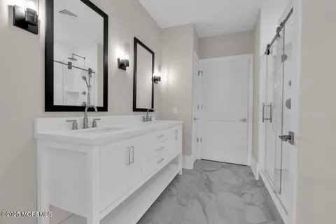 a bathroom with a double vanity sink and mirror