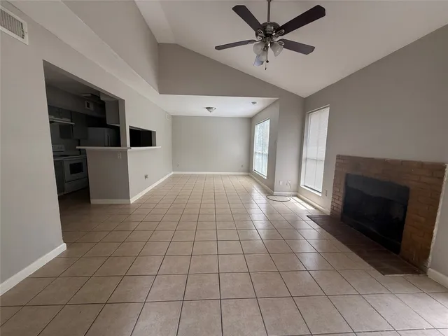 a view of an empty room and fire place