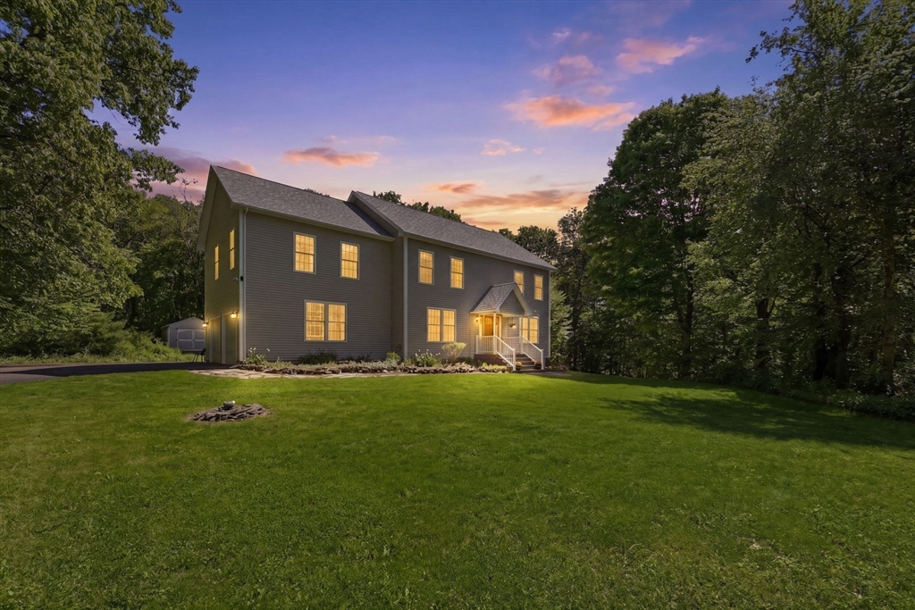 345 Bragg Road Warren, MA 01585 - Photo 4 of 41 a front view of a house with a garden