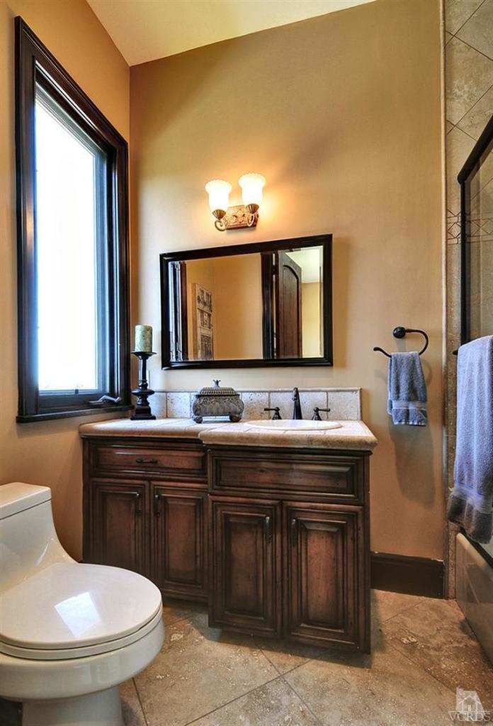 969 North Rancho Road Thousand Oaks, CA 91362 - Photo 22 of 30 a bathroom with a toilet sink and mirror