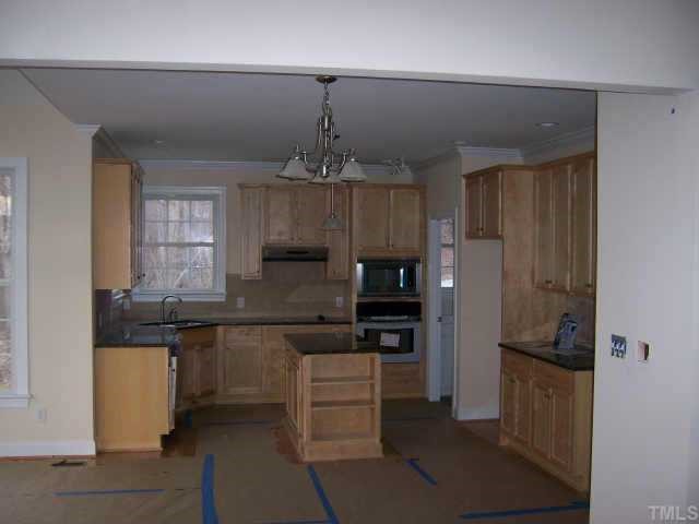 135 Rastille Lane Durham, NC 27712 - Photo 4 of 10 a kitchen with kitchen island a sink stainless steel appliances and cabinets