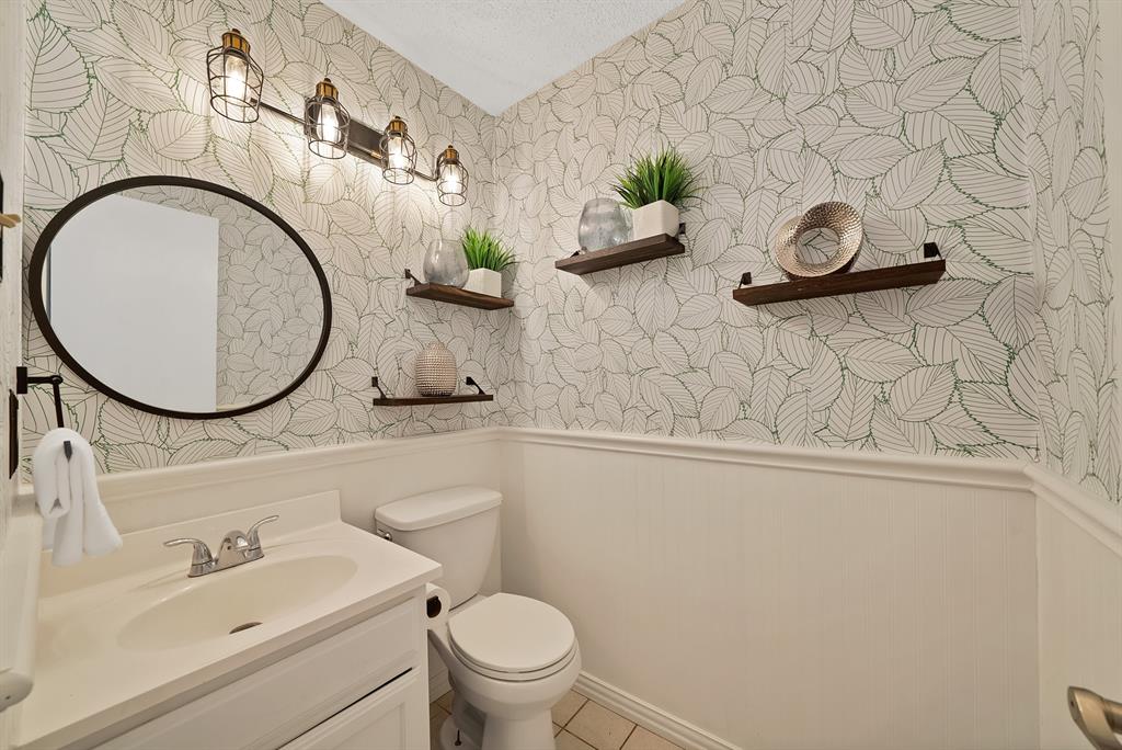 413 Wild Oak Lane Euless, TX 76039 - Photo 15 of 29 a bathroom with a sink mirror vanity and toilet