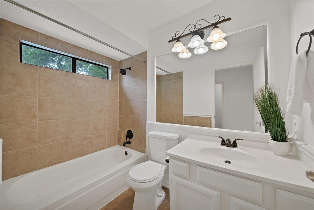 413 Wild Oak Lane Euless, TX 76039 - Photo 19 of 29 a bathroom with a sink a toilet and a large mirror