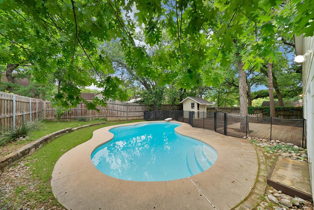 413 Wild Oak Lane Euless, TX 76039 - Photo 23 of 29 a view of a swimming pool with a patio