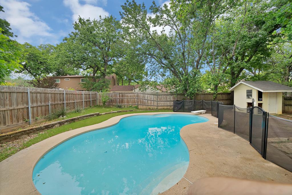 413 Wild Oak Lane Euless, TX 76039 - Photo 24 of 29 a view of a backyard with a small pool and deck