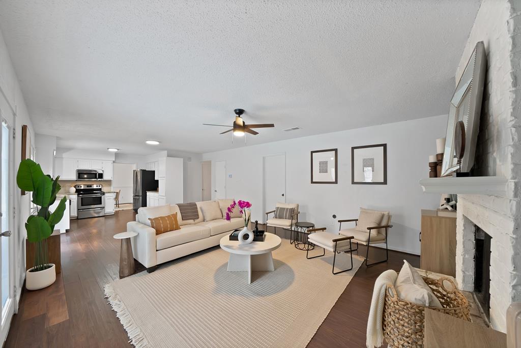 413 Wild Oak Lane Euless, TX 76039 - Photo 6 of 29 a living room with fireplace furniture and a flat screen tv