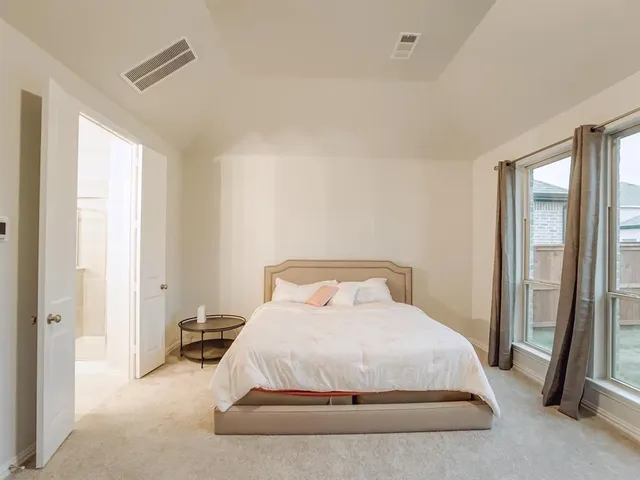 a bedroom with a bed and a mirror