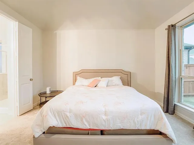 a bedroom with a bed and a large mirror