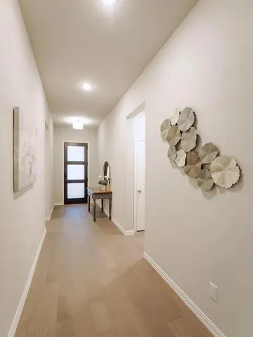 a view of a livingroom with a baby crib cabinets and a window