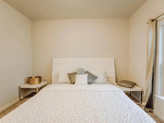 a bedroom with a bed and a table