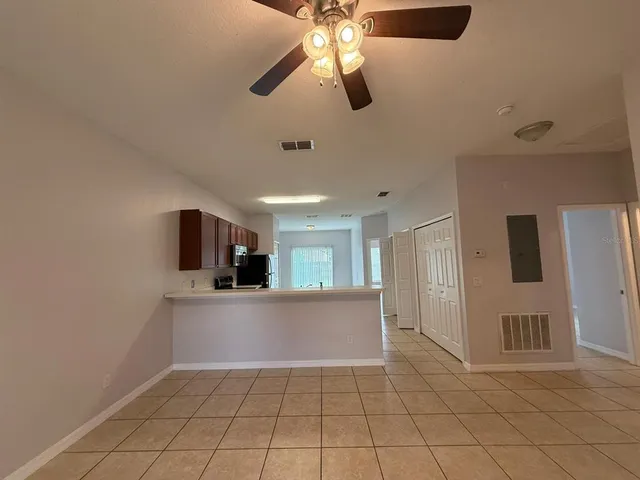 a view of a kitchen with cabinets and stainless steel appliances