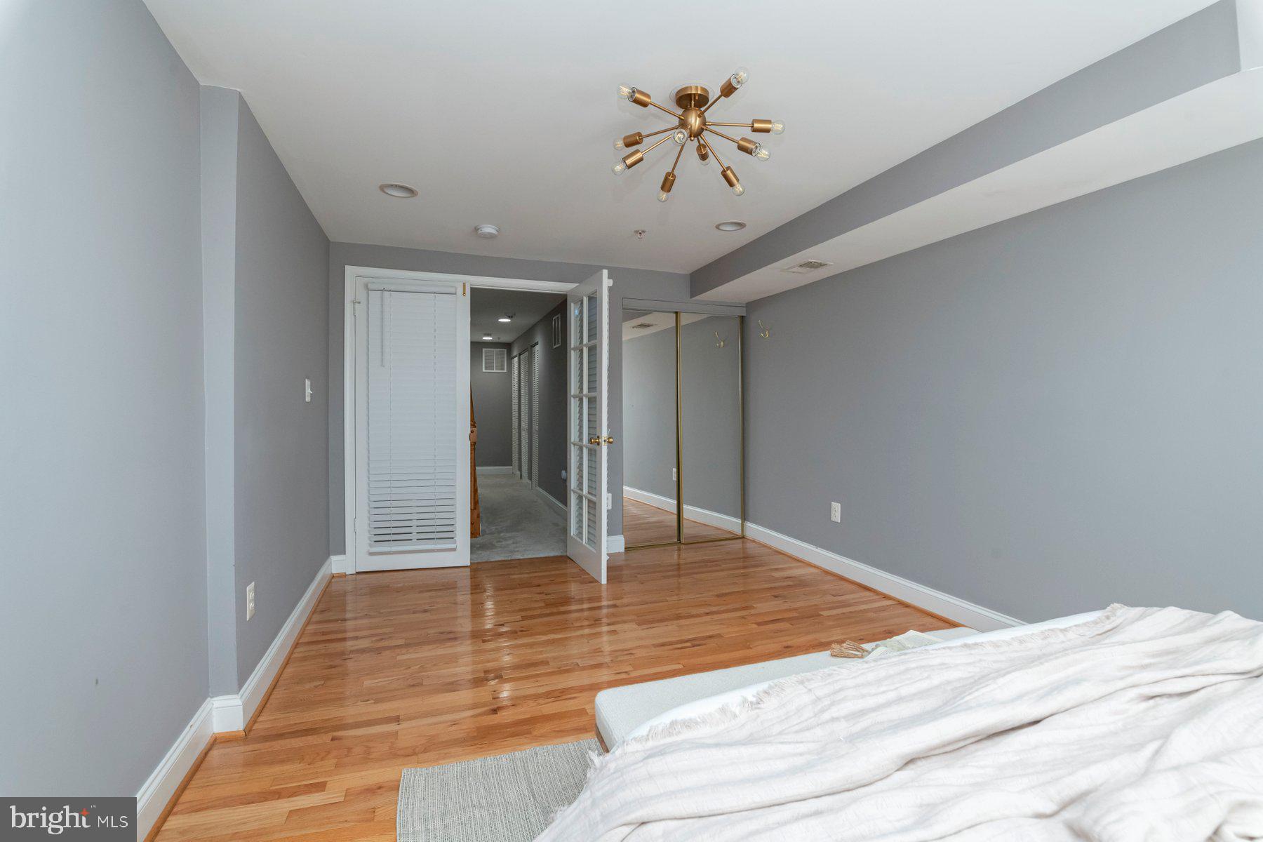 1237 William Street Baltimore, MD 21230 - Photo 16 of 34 a bedroom with a bed and a chandelier