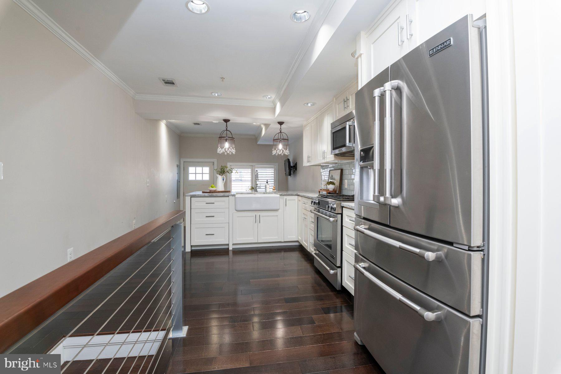 1237 William Street Baltimore, MD 21230 - Photo 5 of 34 a kitchen with cabinets and stainless steel appliances